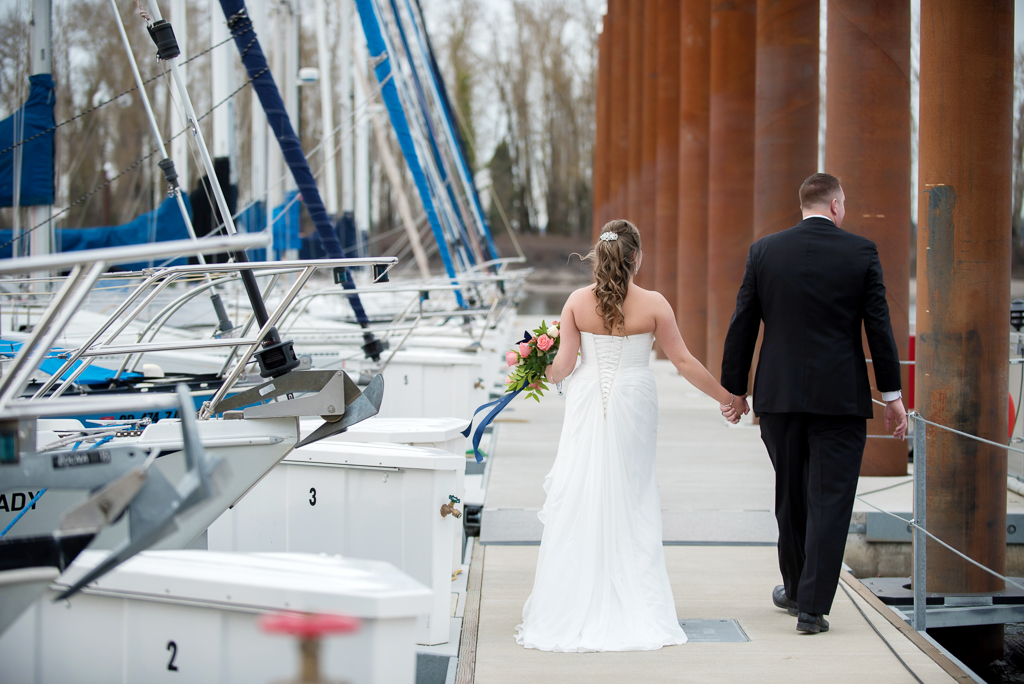 bride and groom walk around the marina