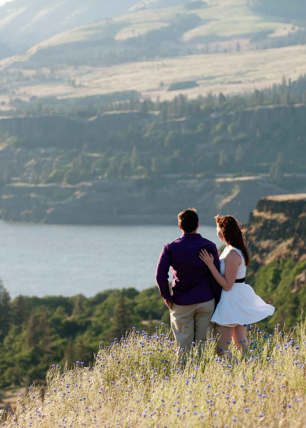 a couple stand lookout out over the columbia river gorge from rowena crest
