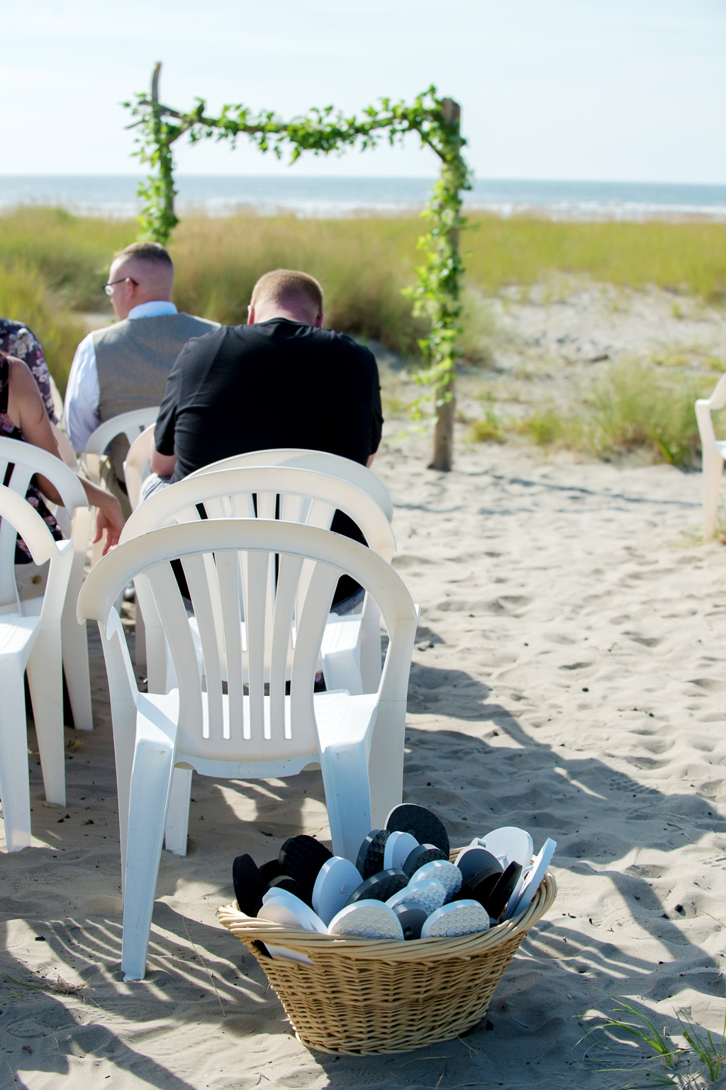 a basket of flip-flops for guests to wear at beach wedding