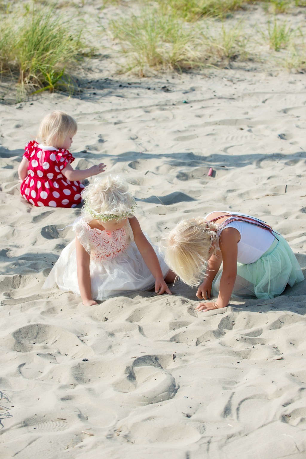 children play in the sand during a beach wedding