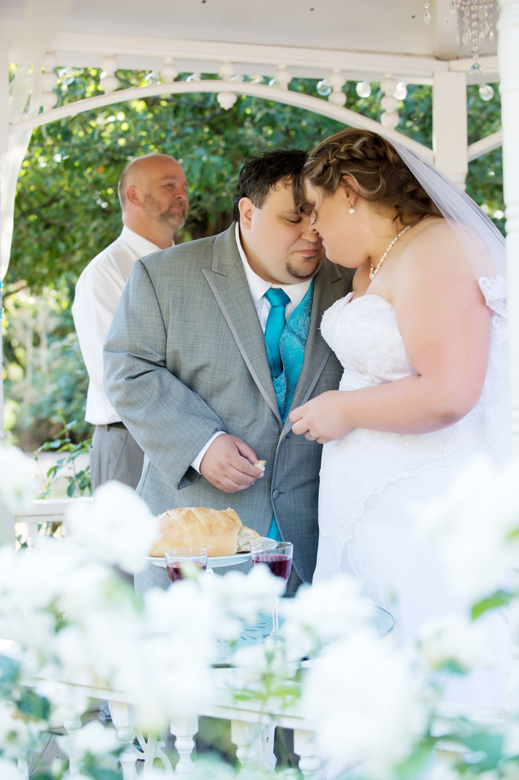bride and groom break bread during wedding ceremony