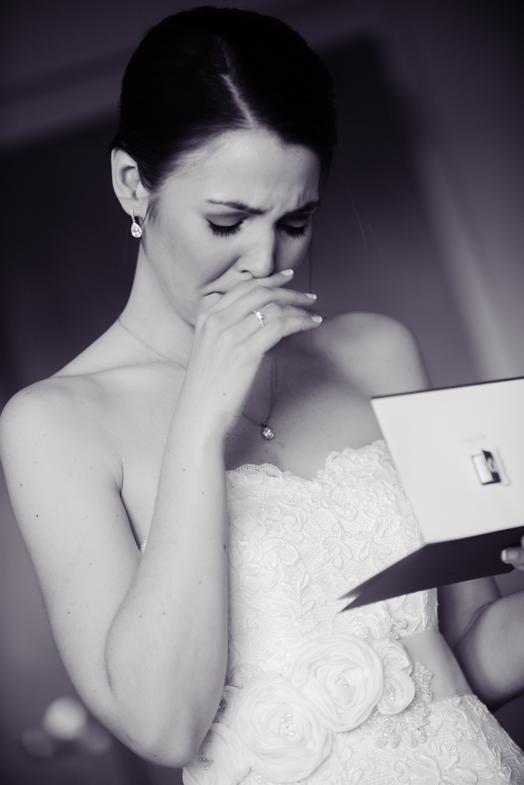 a bride cries as she reads a letter from her groom