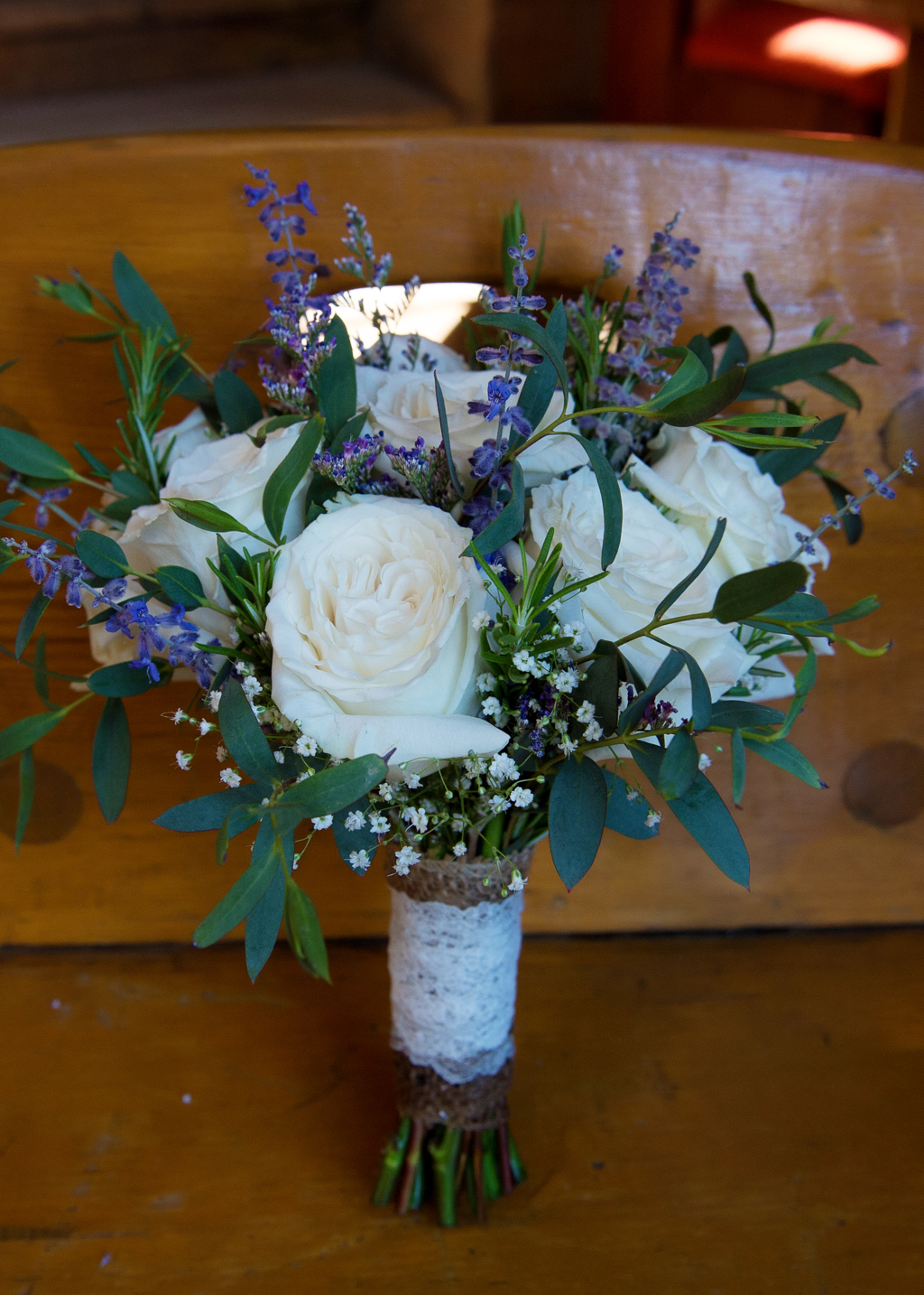 white roses and purple flowers wedding bouquet