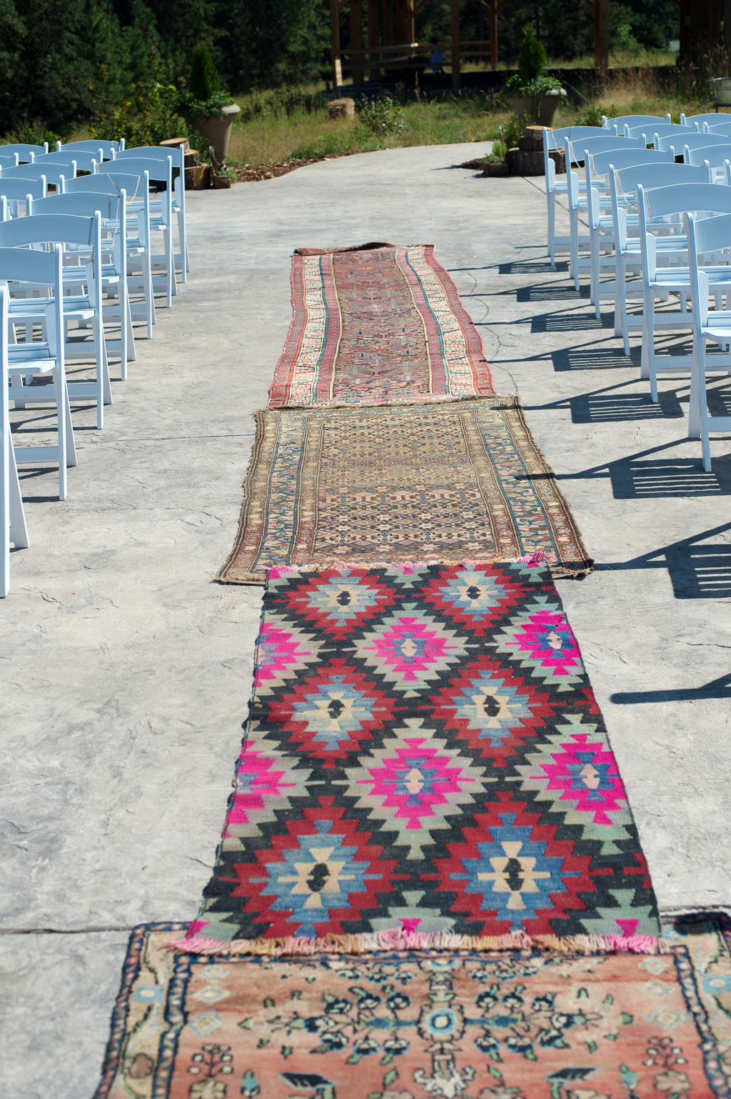 vintage persian rugs line the wedding ceremony aisle