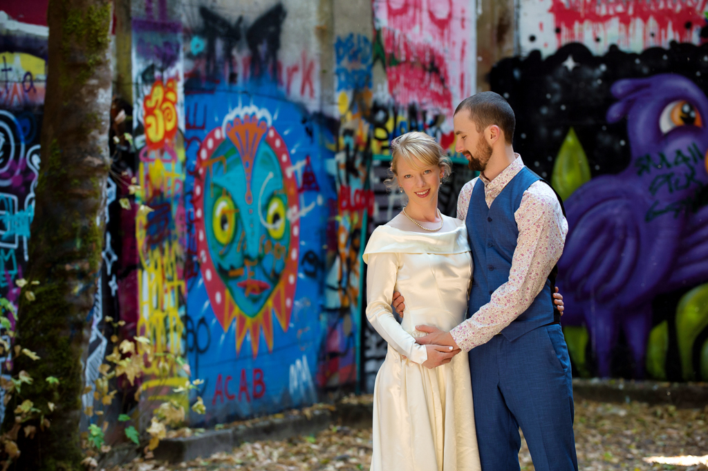 a bride and groom in an old mill covered in graffiti in Vernonia