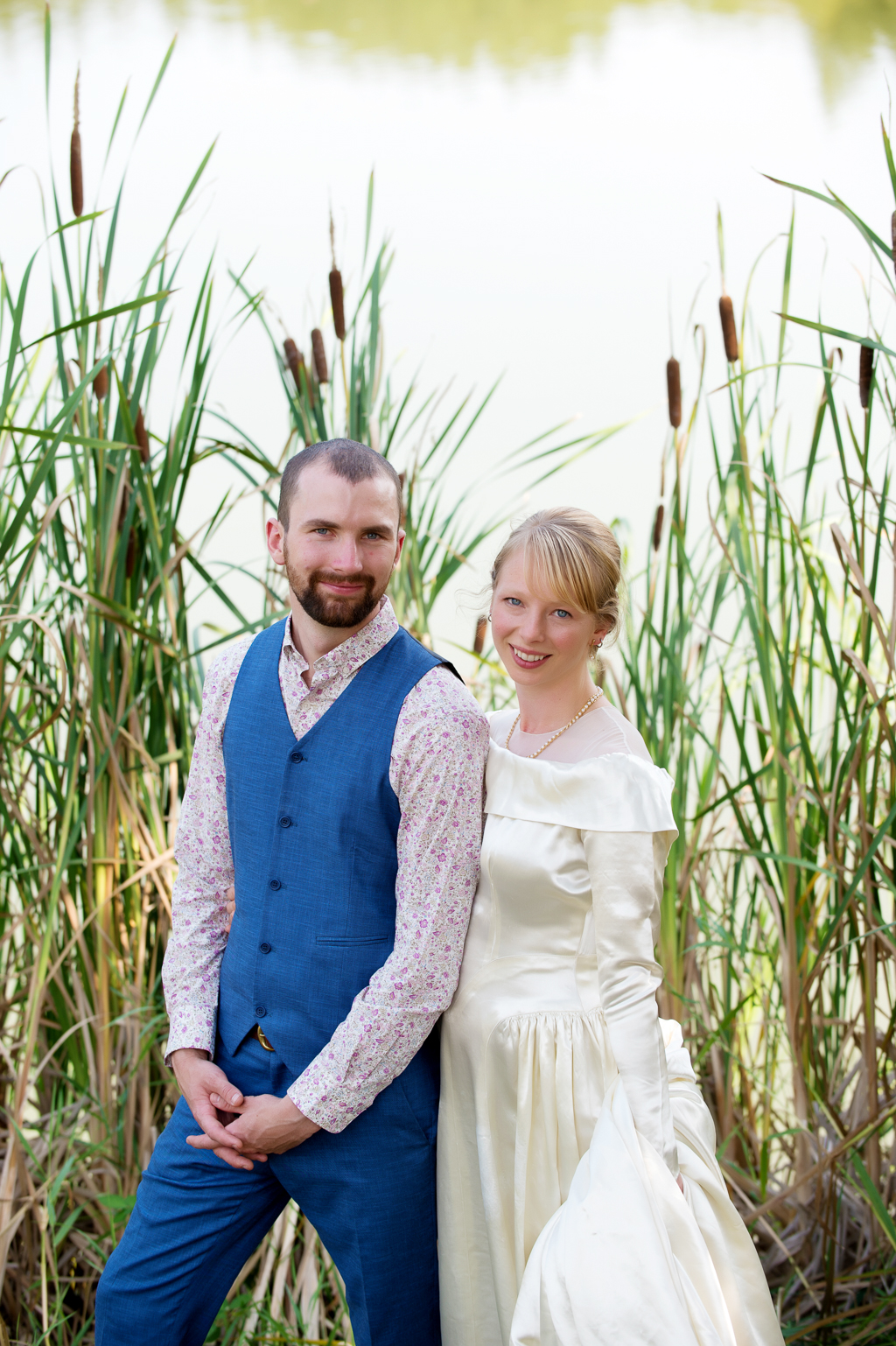 a bride and groom pose in front of vernonia lake