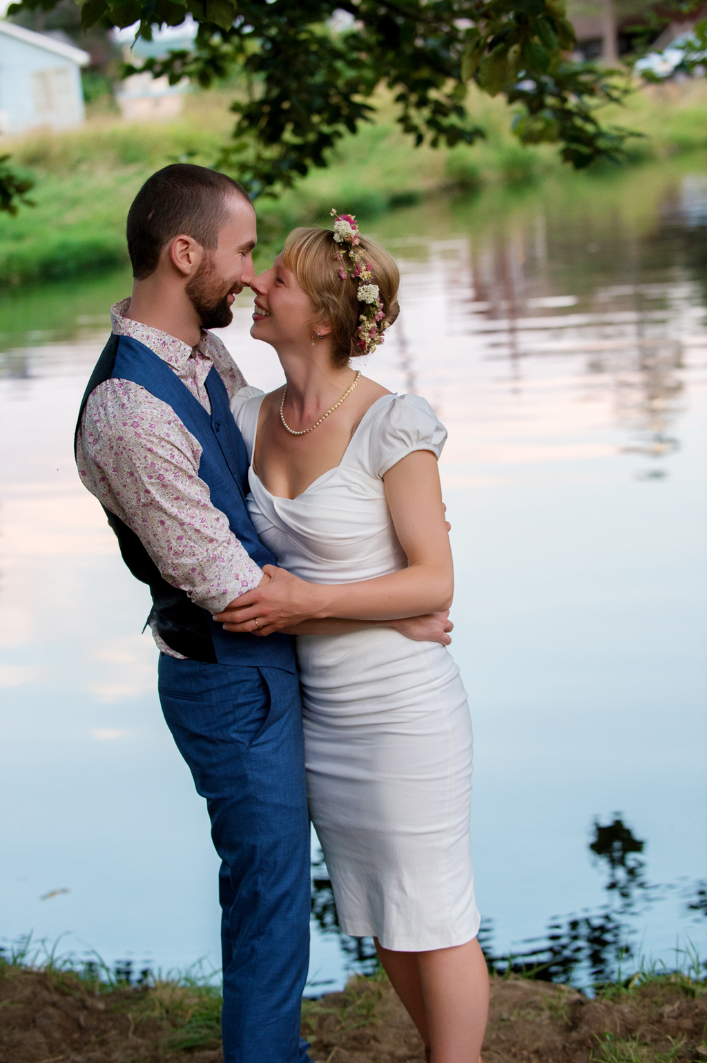 a bride and groom embrace in front of nehalem river in vernonia