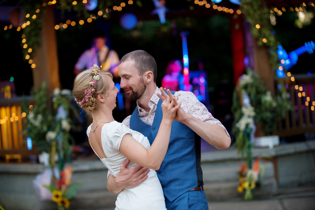 bride and groom have first dance in hawkins park while band plays in gazebo behind them