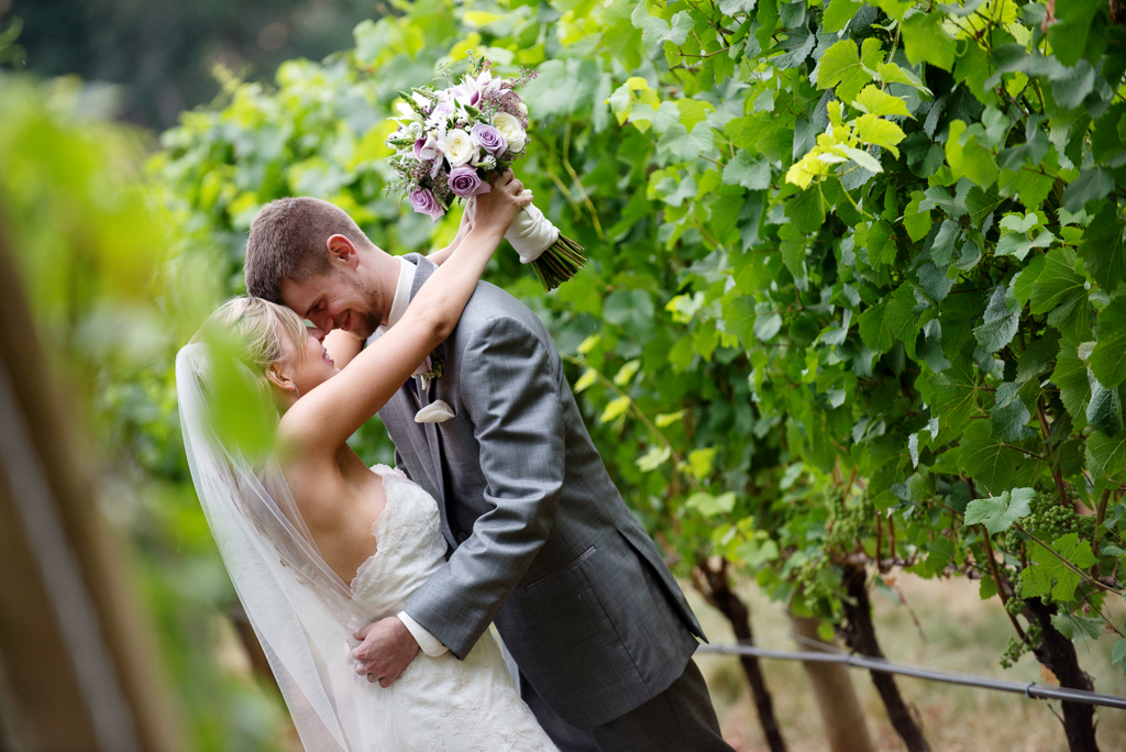 a bride and groom embrace in the vineyard at vista hills
