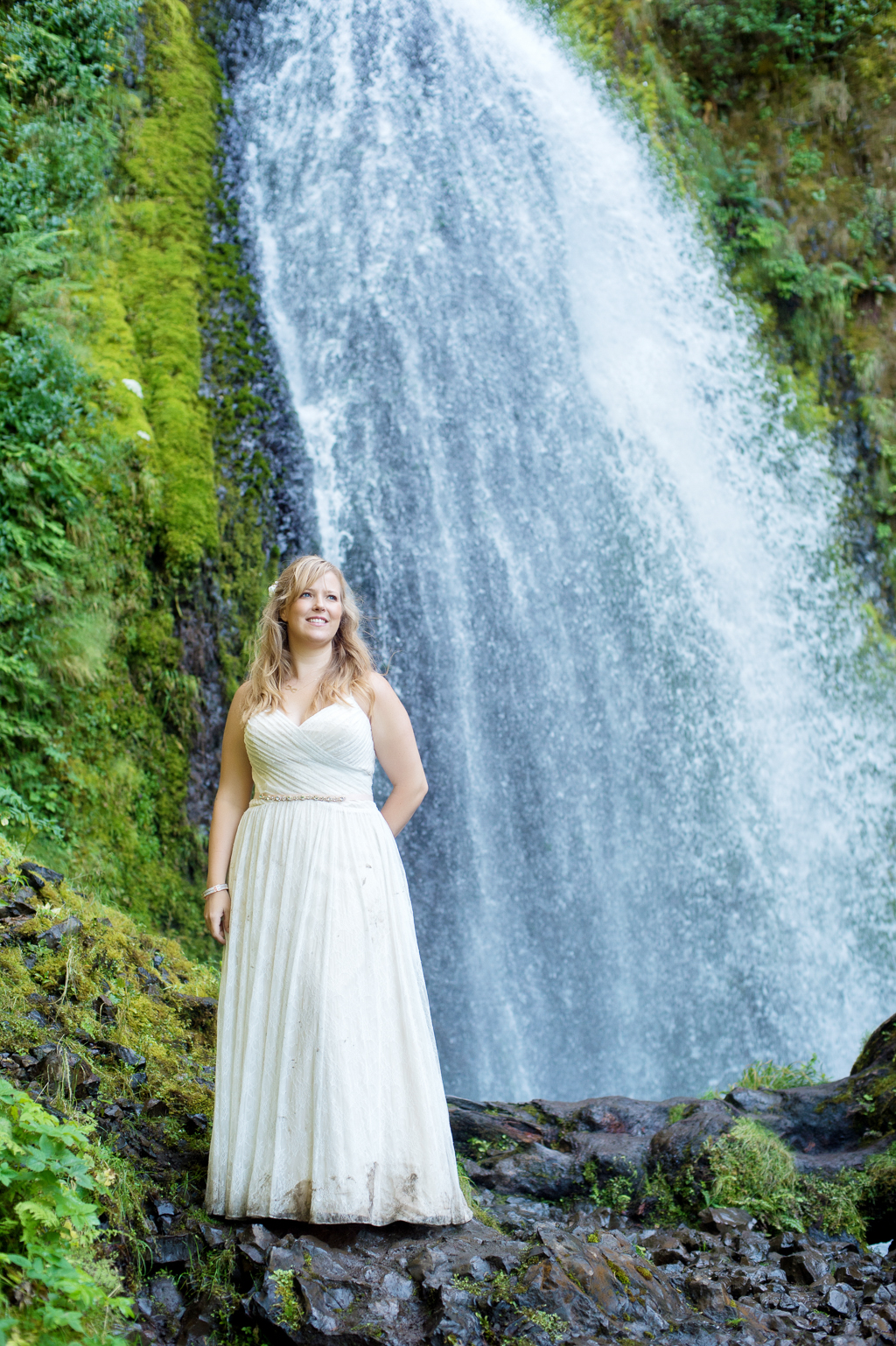 a bride stands in front of wahkeena falls
