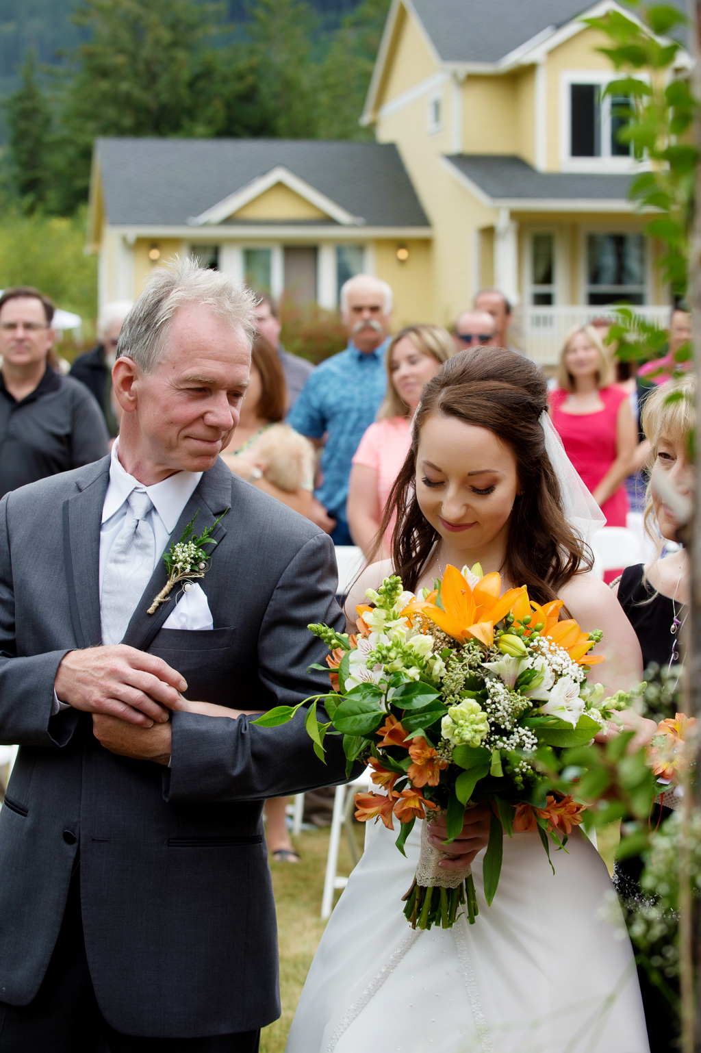 a father of the bride gives his daughter a sweet look as he walks her down the aisle