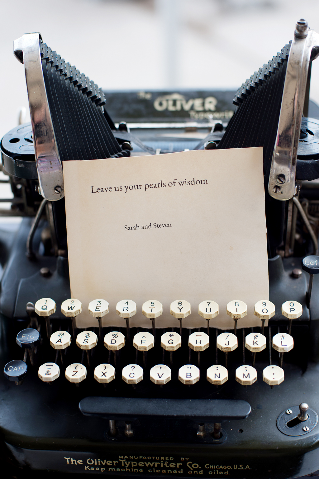 a vintage oliver typewriter is used to type notes to the married couple at their wedding reception