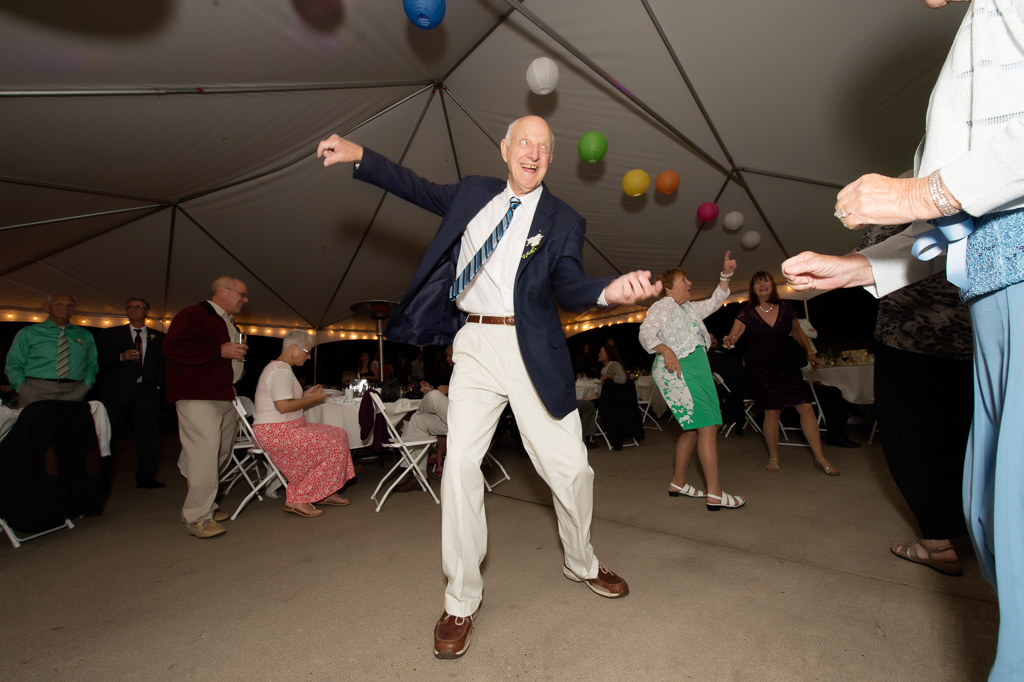 a grandpa dances crazily at a wedding reception