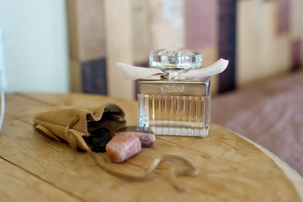 a satchel of crystal stones and chloe perfume for the wedding day