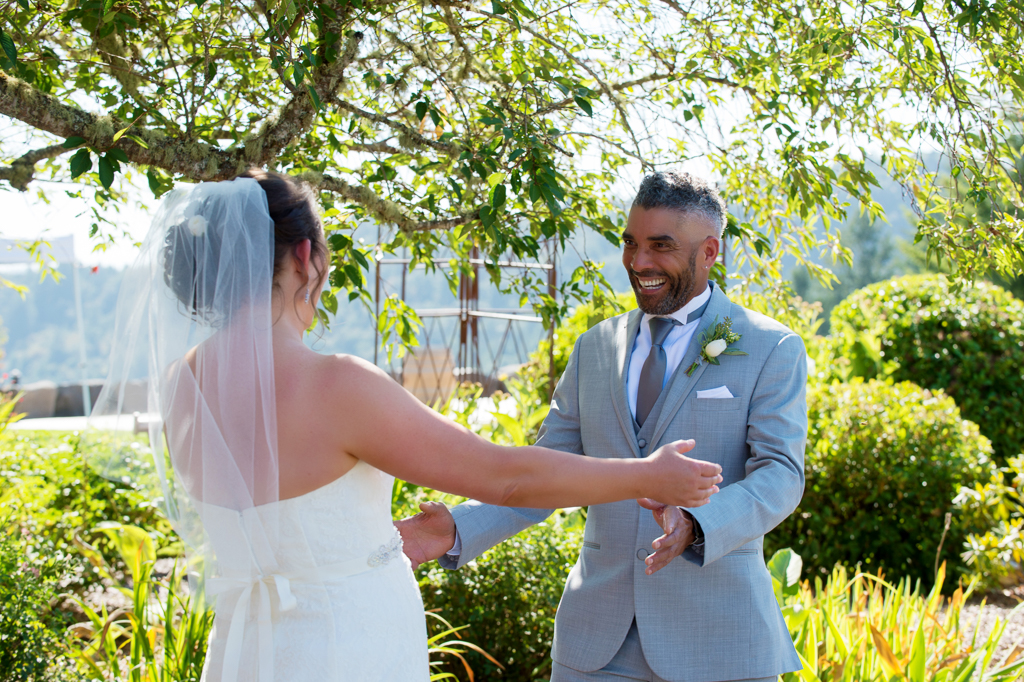 a groom is happy to see his bride for the first time on their wedding day