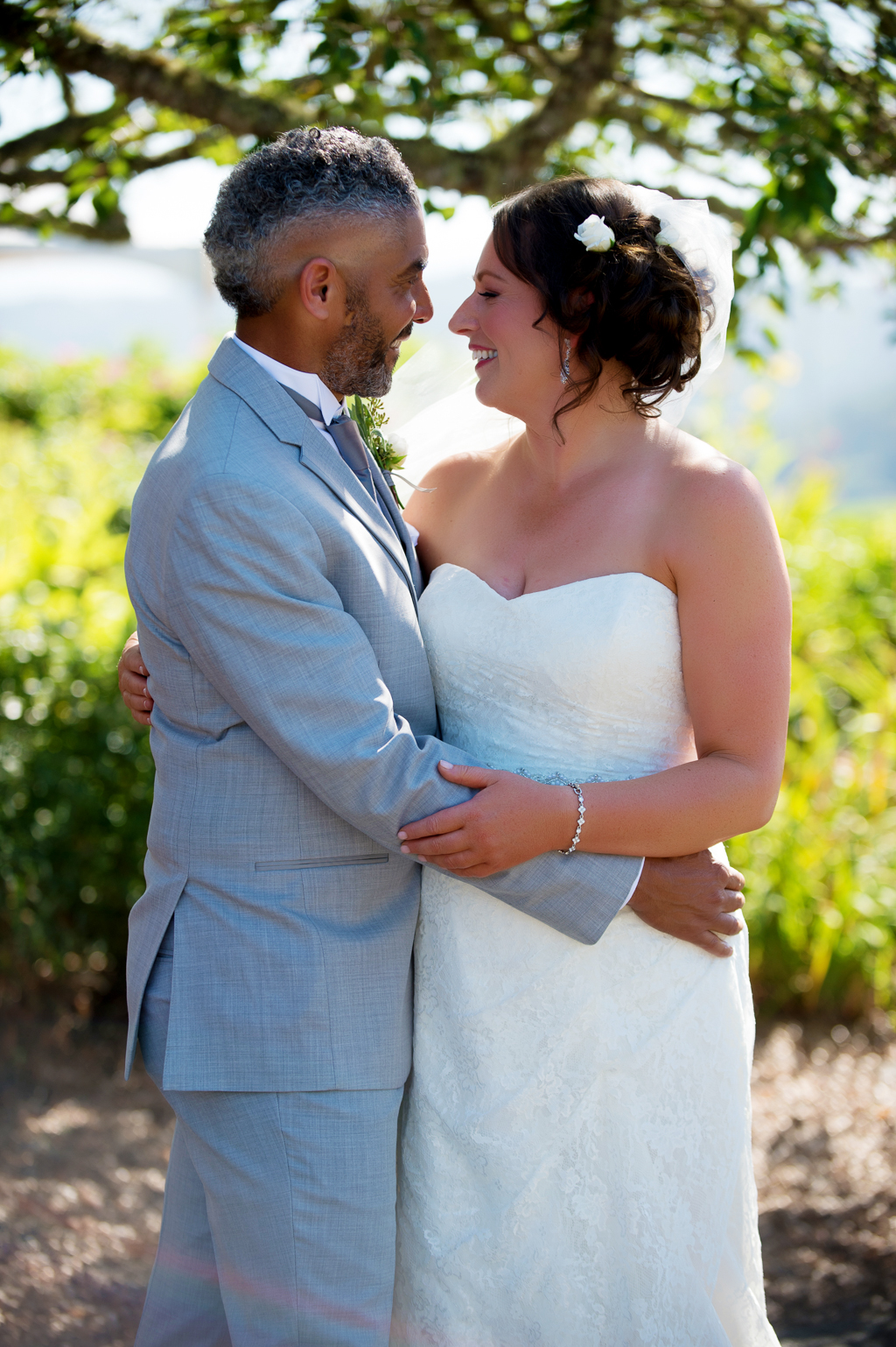 a bride and groom embrace at youngberg hill vineyard