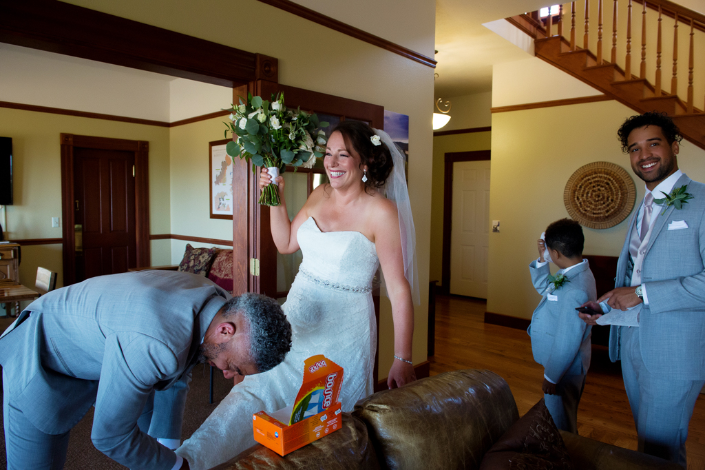 a groom rubs downy dryer sheets all over a bride to help keep the bumble bees off of her