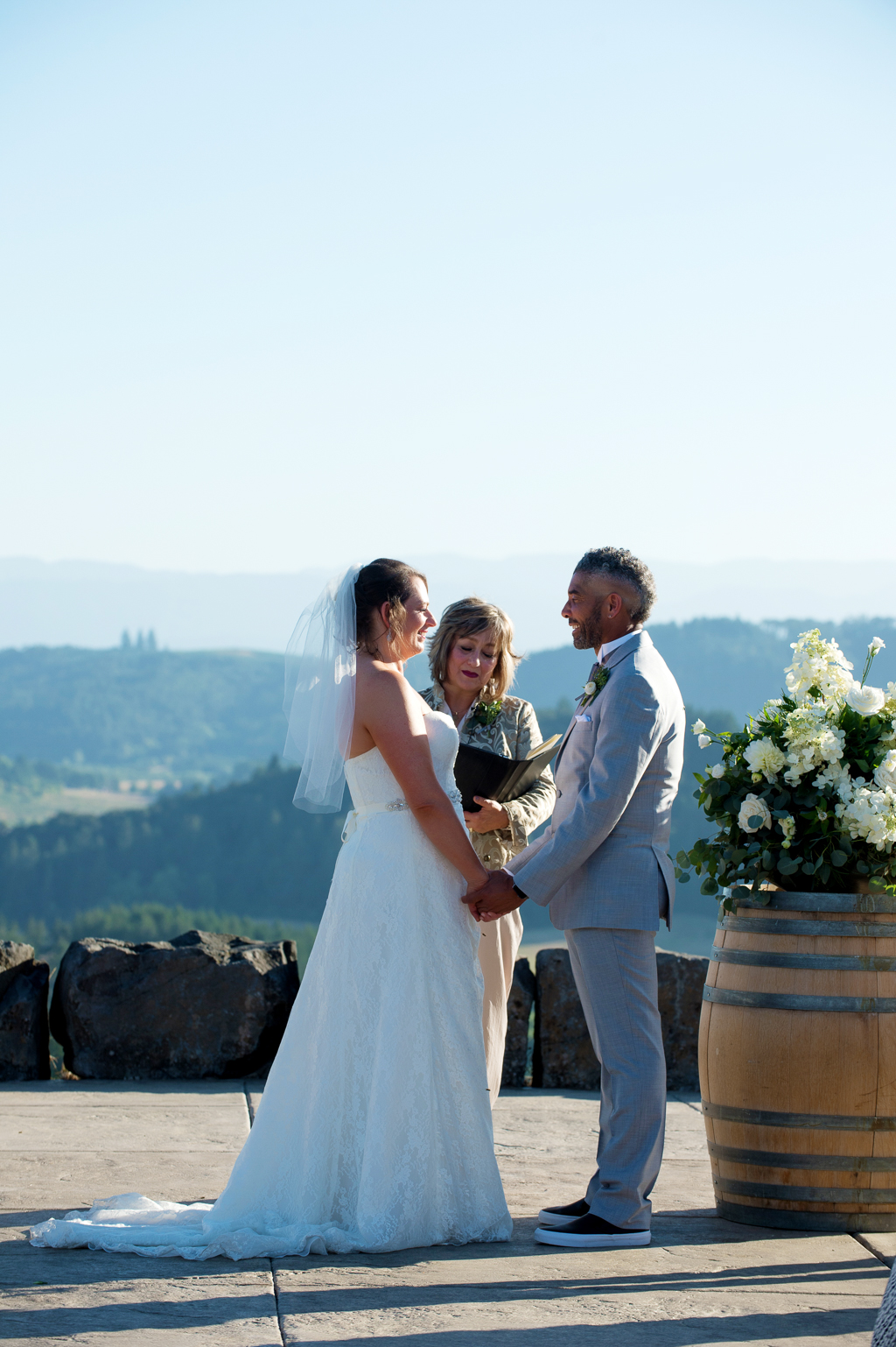 a couple stand in front of youngberg hill vineyard for their wedding ceremony