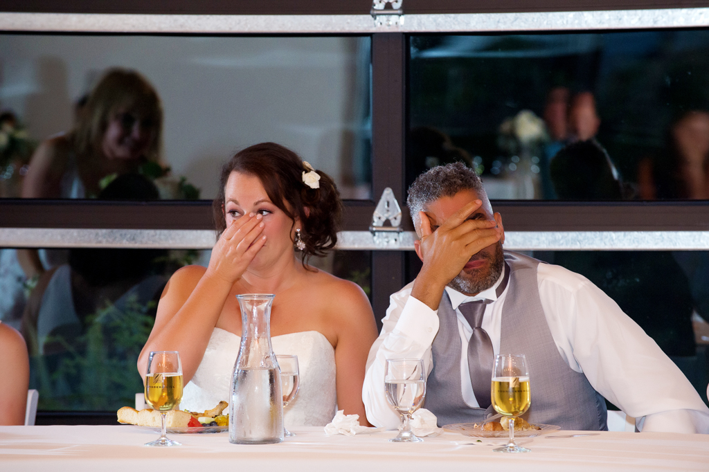 a bride and groom get emotional during a wedding reception toast