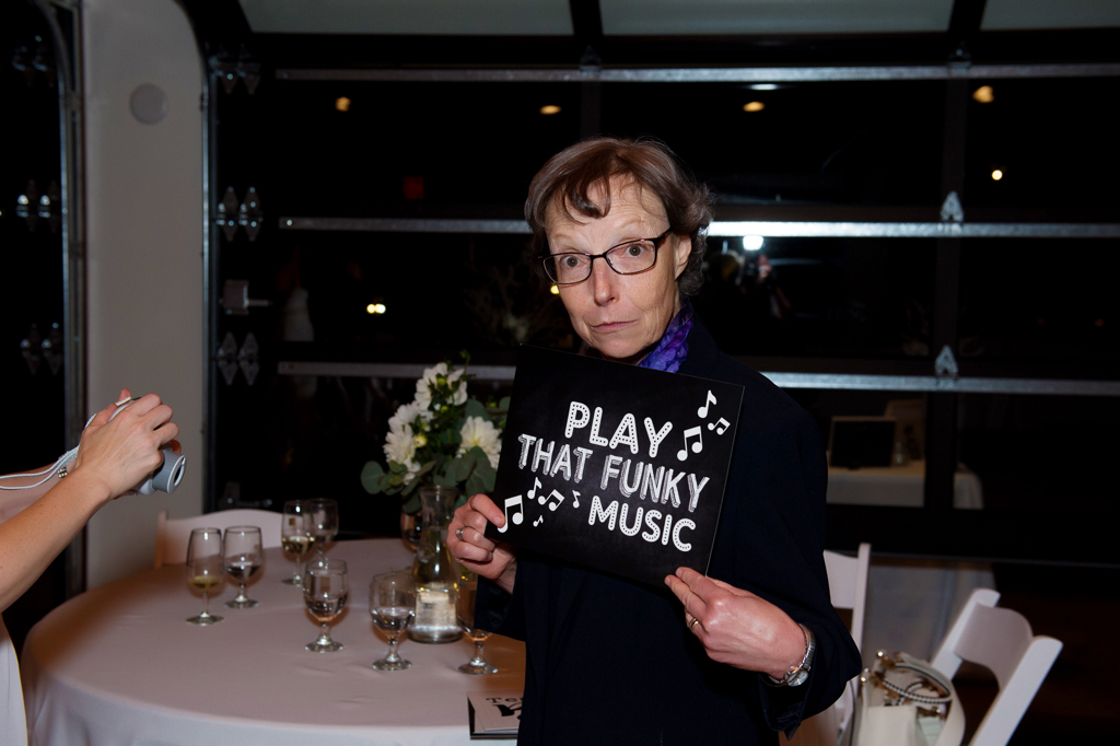 a woman holds a sign that says play that funky music