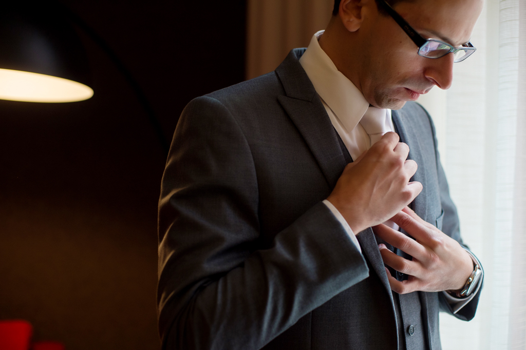 groom fixes his tie