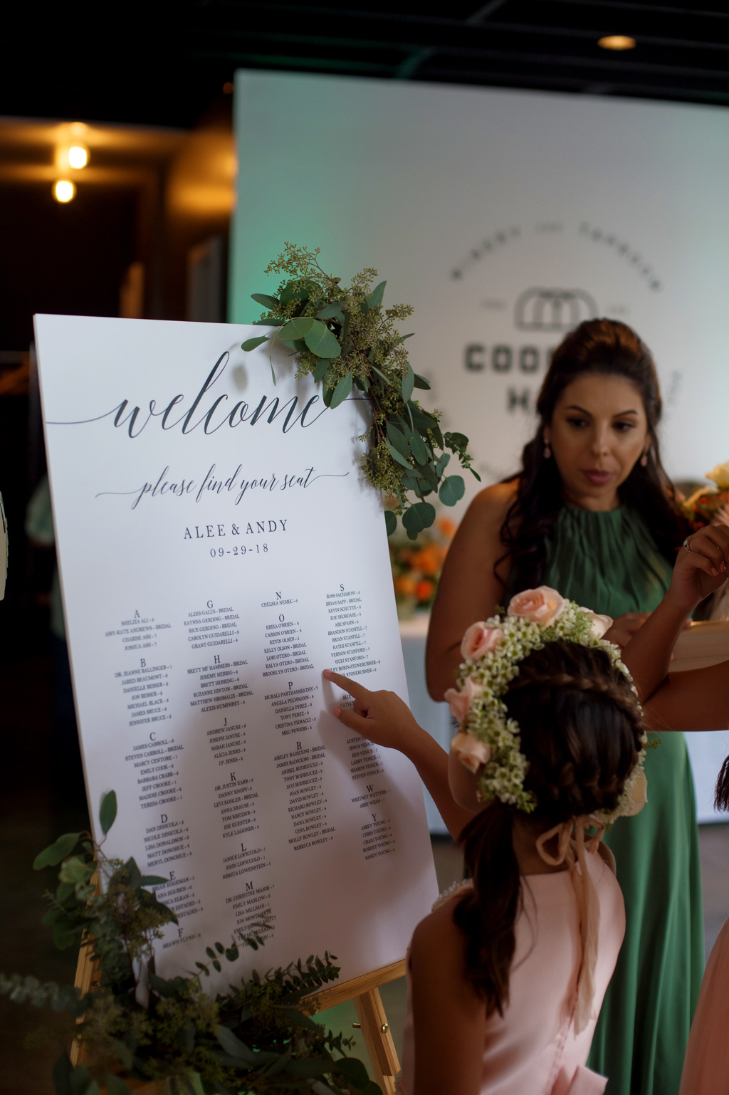 a flower girl finds her name on the seating chart at a wedding at coopers hall