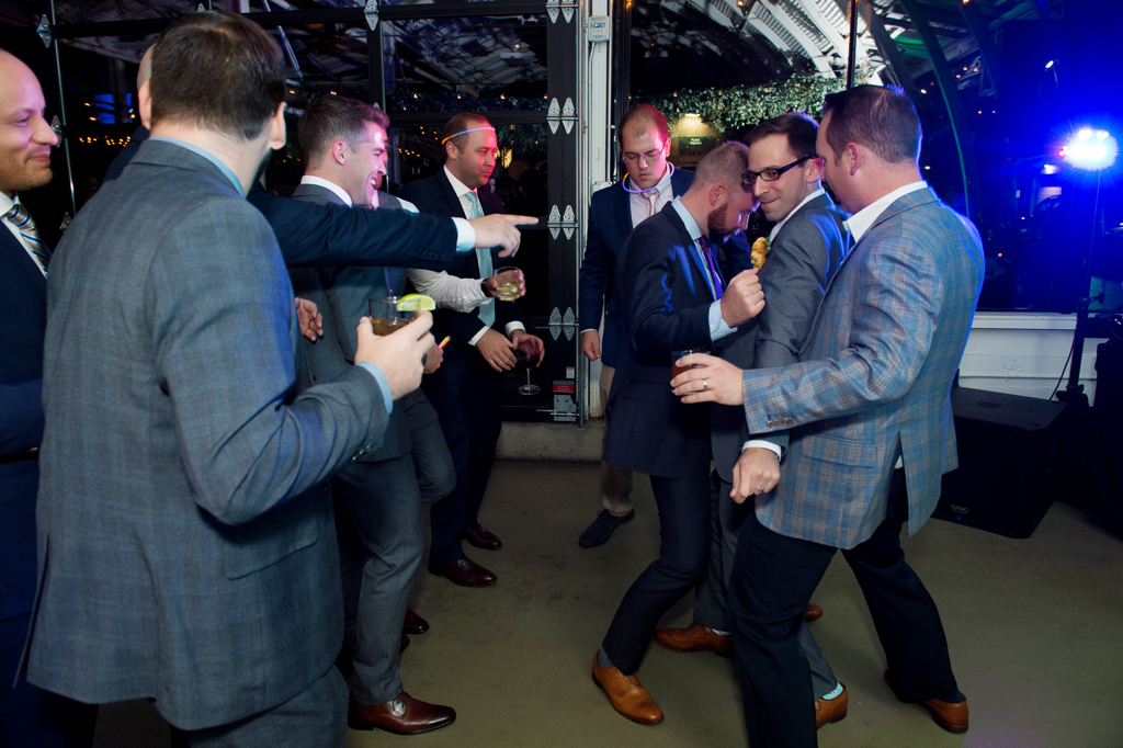 groom dances with a lot of groomsmen at coopers hall