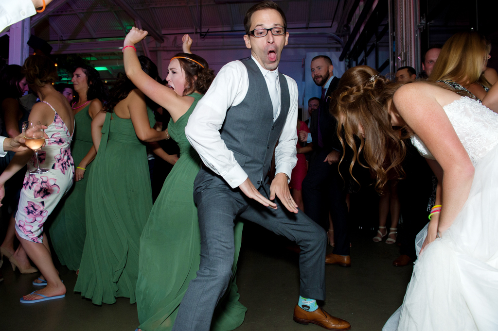the groom dances crazy with a bridesmaid while the bride laughs hysterically in the foreground at coopers hall