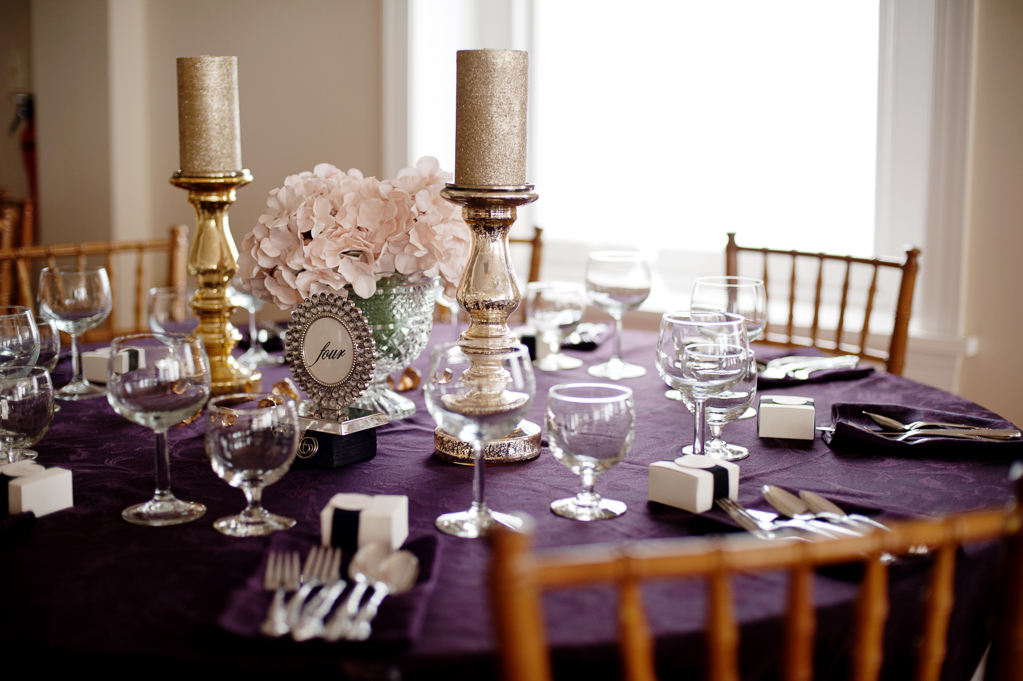 pink and gold decor on purple tablecloth