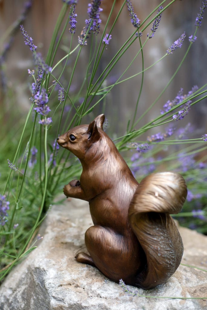 a bronze sculpture of a squirrel 
