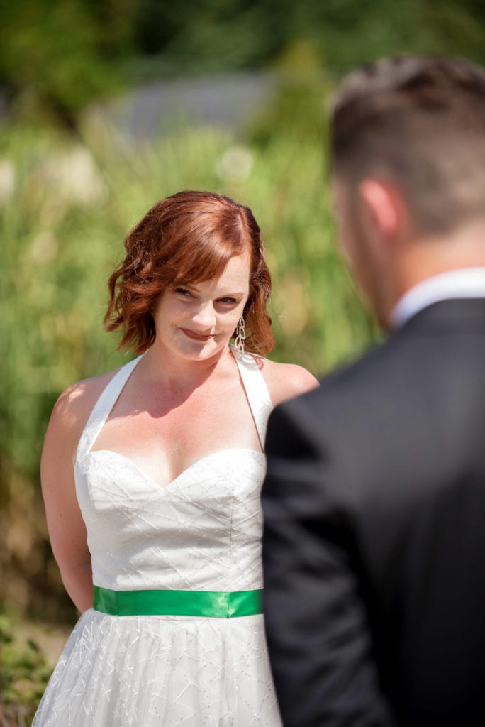 a bride gives a sweet look during her wedding ceremony 