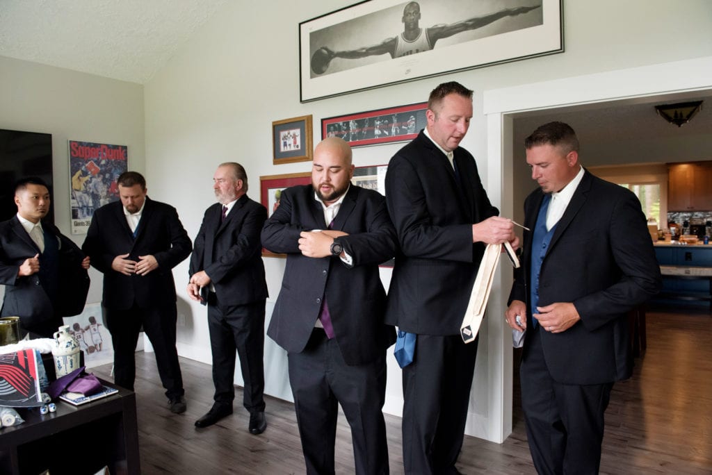 groomsmen get ready with ties and cufflinks
